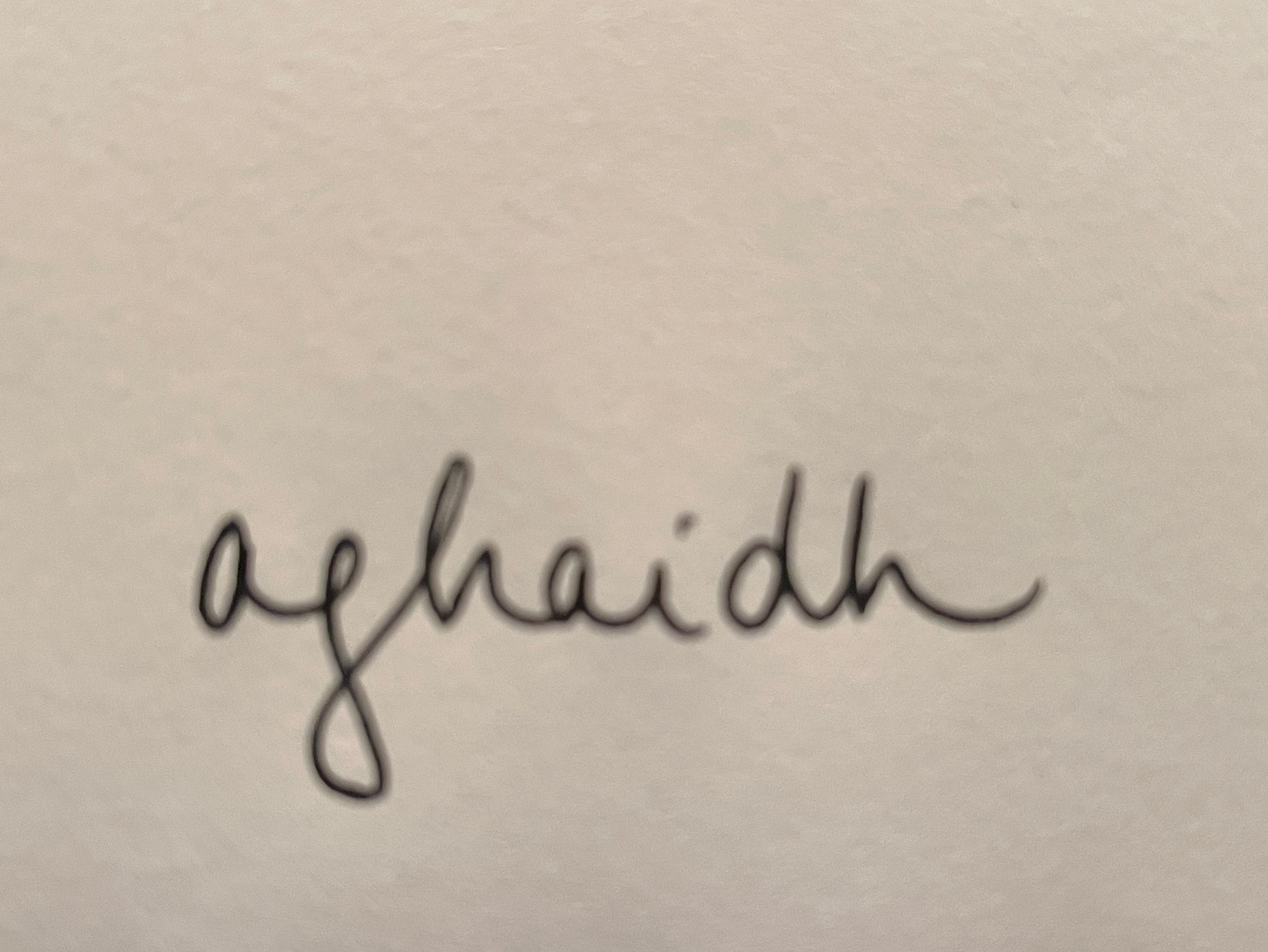 the word “aghaidh,” handwritten in black on a white background
