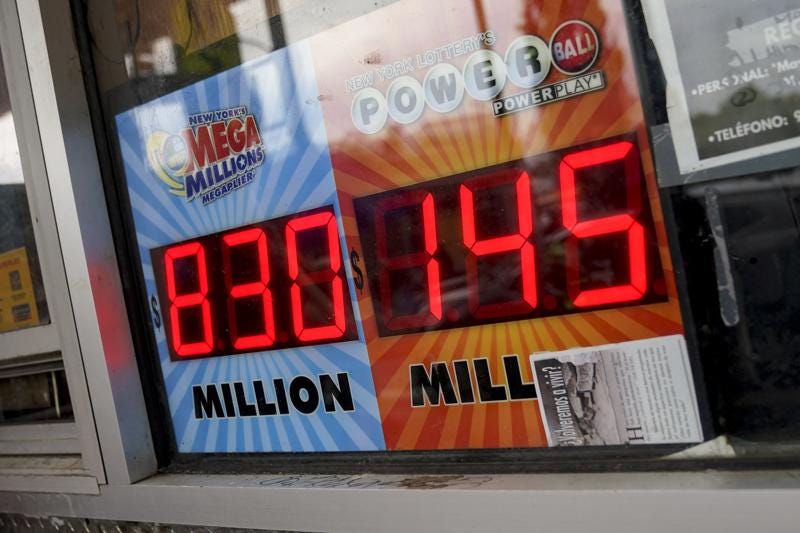 The Mega Millions lottery jackpot is advertised outside a smoke shop in the Bushwick neighborhood in the Brooklyn borough of New York, Tuesday, July 26, 2022. The payoff for Tuesday night's drawing is an estimated $810 million, the nation's fourth-largest jackpot. (AP Photo/John Minchillo)