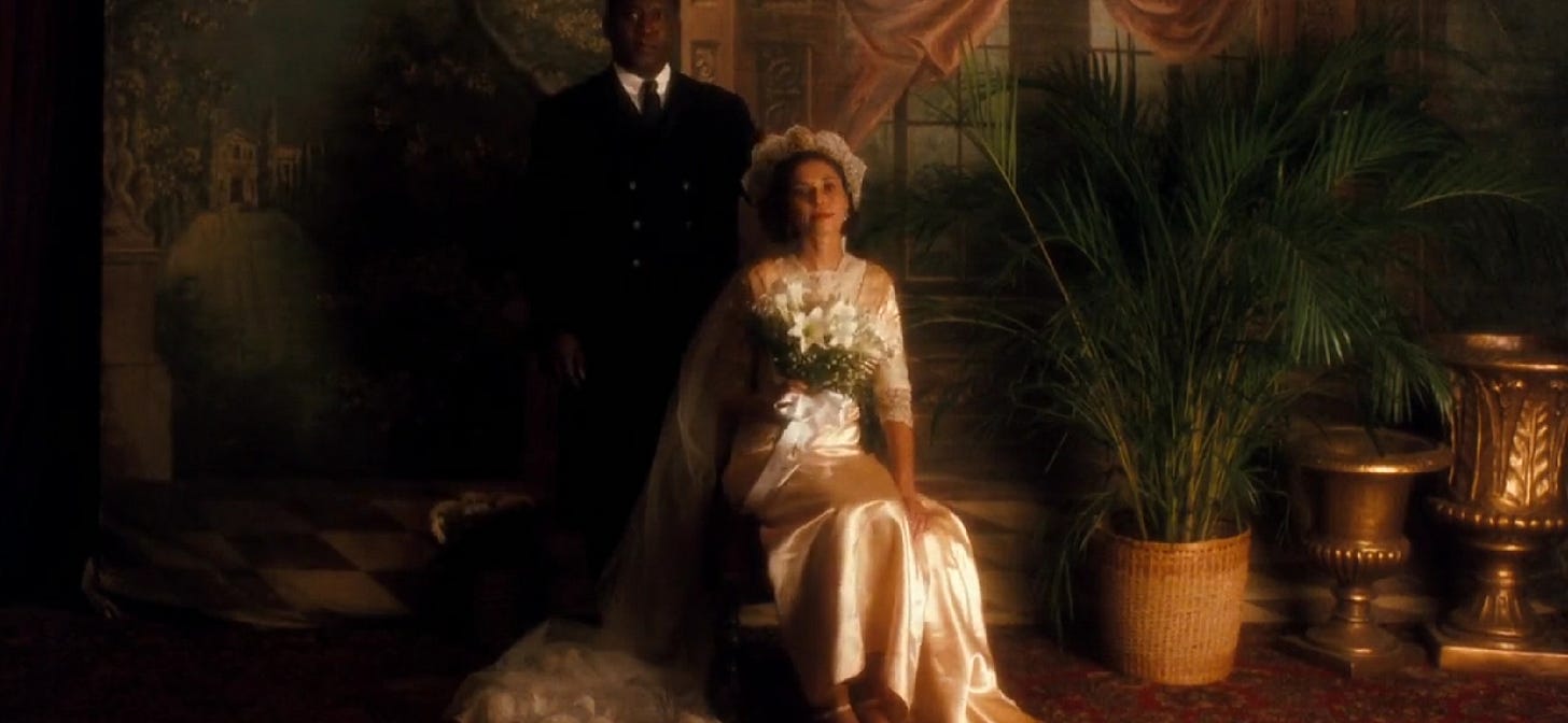 This image shows Malcolm X's parents, Earl Little (played by Tommy Hollis, standing) and Louise Little (played by Lonette McKee, seated) on their wedding day, as depicted in Spike Lee's 1992 movie Malcolm X. This image shows Malcolm X's parents, Earl Little (played by Tommy Hollis, standing) and Louise Little (played by Lonette McKee, seated) on their wedding day, as depicted in Spike Lee's 1992 movie Malcolm X.