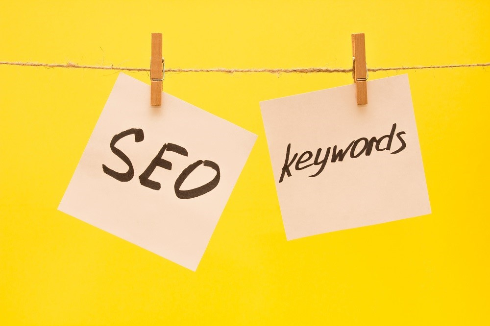 seo and keywords written on paper pegged to a line