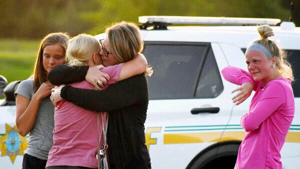 People console each other after a shooting at Cornerstone Church on Thursday, June 2, 2022 in Ames, Iowa. Two people and a shooter died Thursday night in a shooting outside a church in Ames, authorities said.