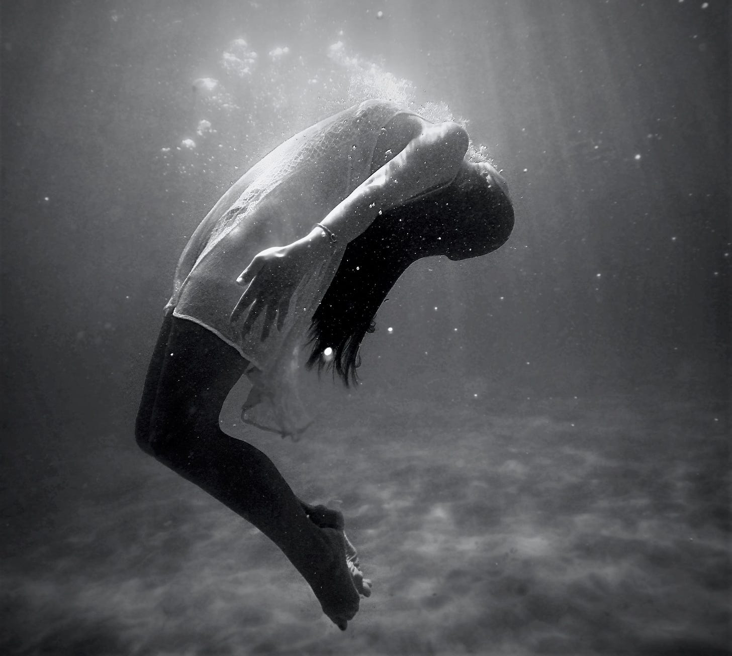 black and white photos of girl floating in water