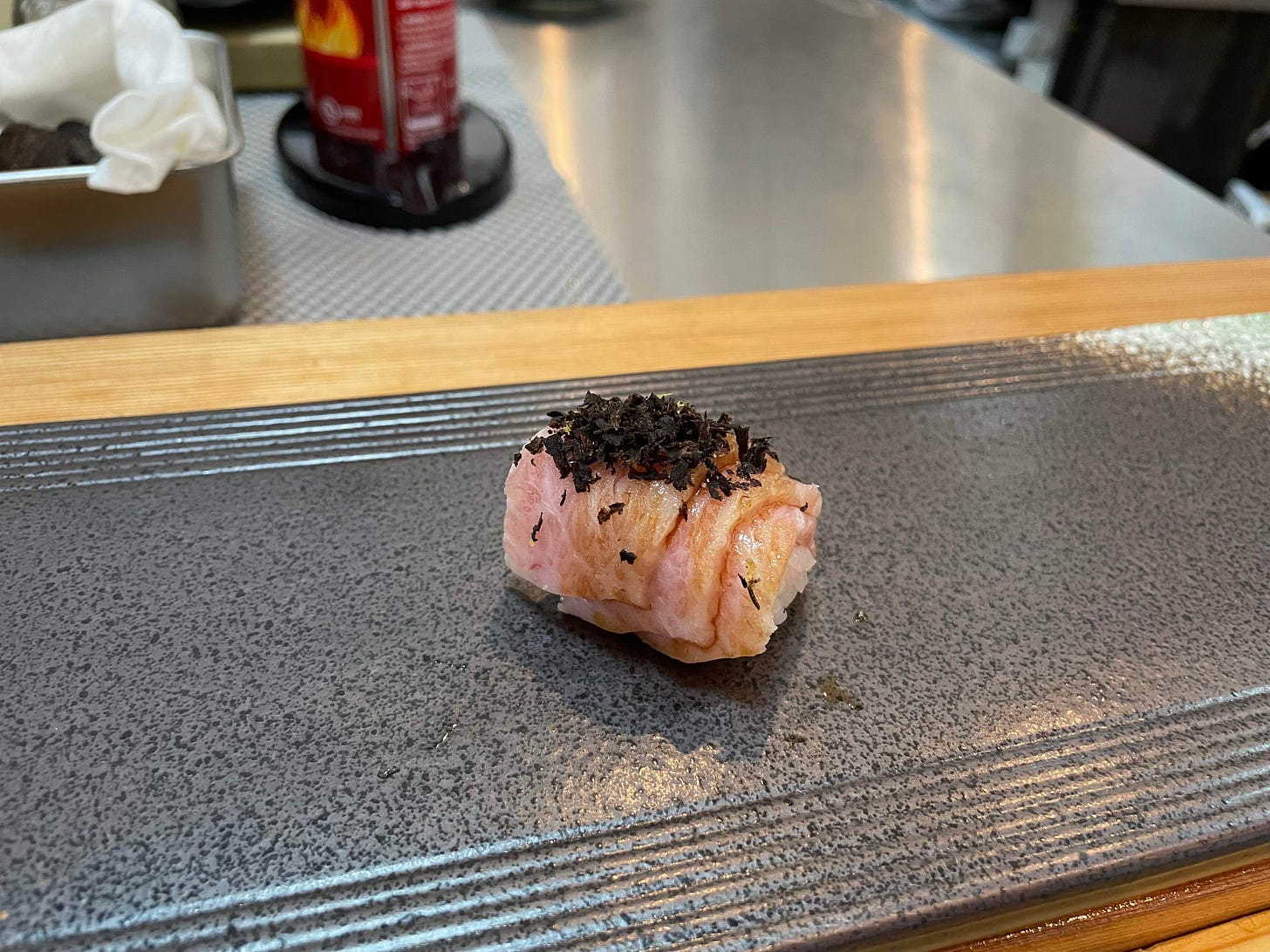 Three slices of tuna and shaved truffle.