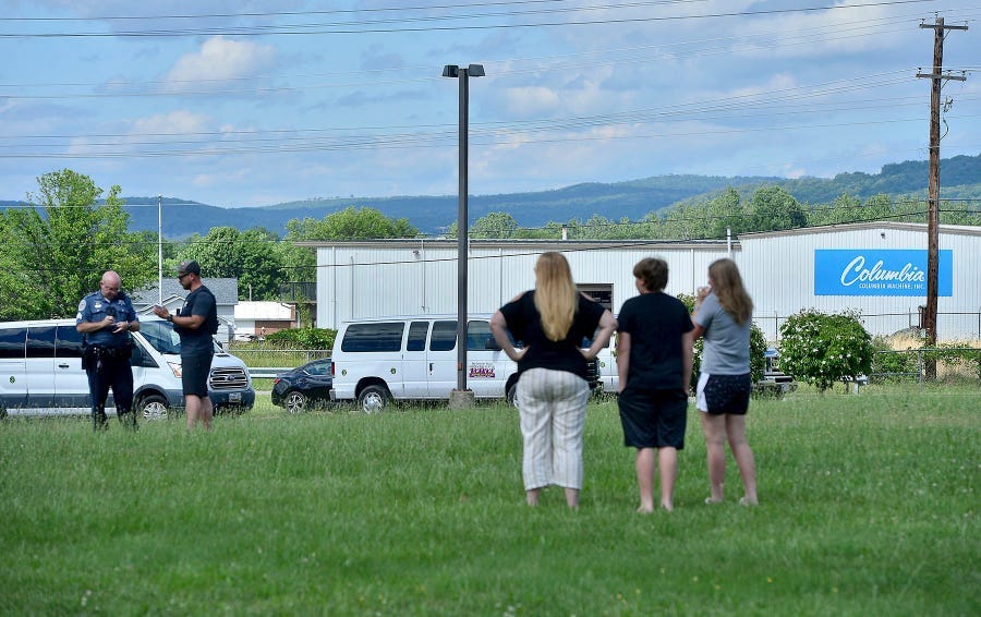 A Washington County Sheriff's Office deputy talks to bystanders following a shooting at Columbia Smithsburg manufacturing Thursday, June 9, 2022 in Smithsburg, Maryland.