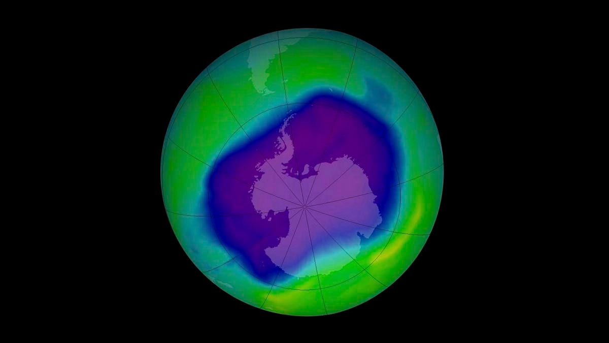 A view of planet Earth showing a purple blotch over the Antarctic representing a hole in the ozone layer of the atmosphere.