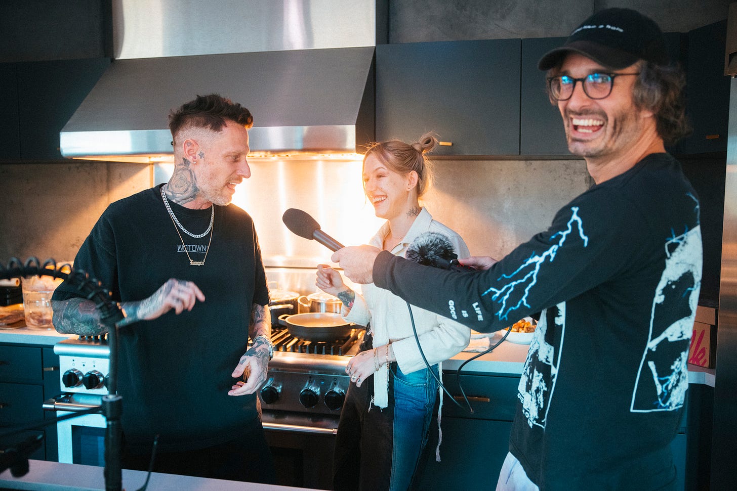 Celebrity chef Michael Voltaggio, actor Bria Vinaite, and me all grinning in the kitchen as a turkey cooks