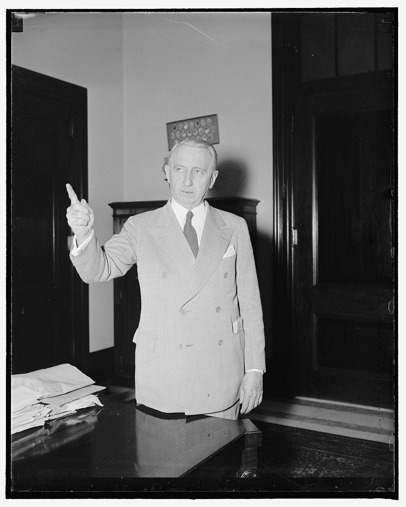 Middle-aged white man in suit, standing