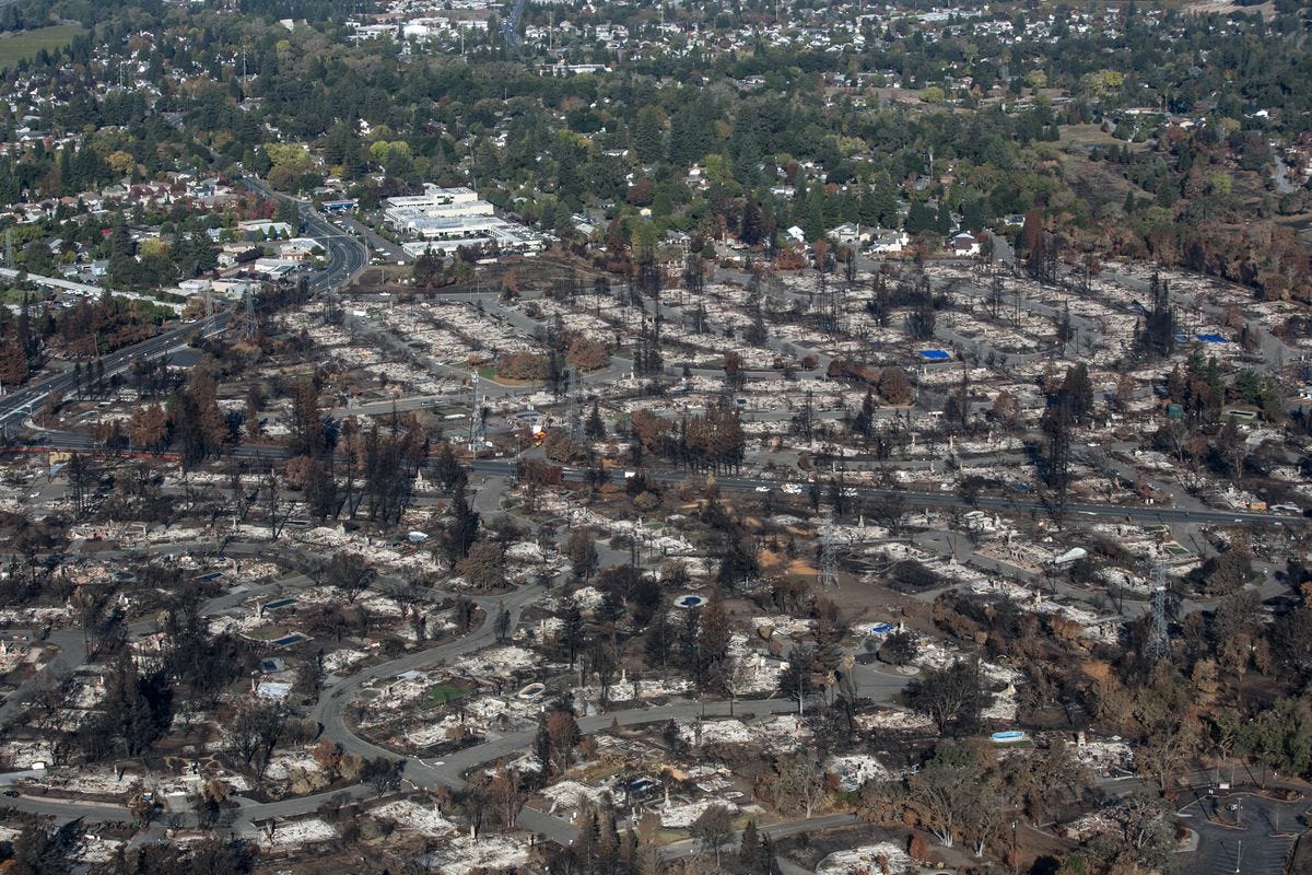 SANTA ROSA, CA - NOVEMBER 5:  The aftermath of a firestorm that began in Napa Valley's Calistoga, destroying thousands of homes in the Coffey Park, Fountaingrove, Larkfield, and Mark West Estates neighborhoods, is viewed from this aerial photo taken over burned-out Mark West Estates on November 5, 2017, in Santa Rosa, California. Officials are calling it the most destructive wildfire in the State's history, the Tubbs Fire roared through forested hillsides before descending into densely populated neighborhoods, destroying more than 6,000 homes, out buildings, and businesses, resulting in an estimated $3 billion in damage, 24 deaths, and leaving thousands homeless. (Photo by George Rose/Getty Images)