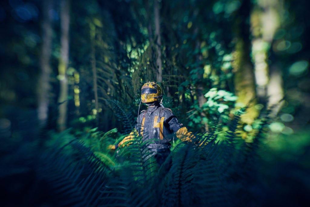 A lost inmate from an apocalyptic jail wanders the forest wearing a yellow helmet