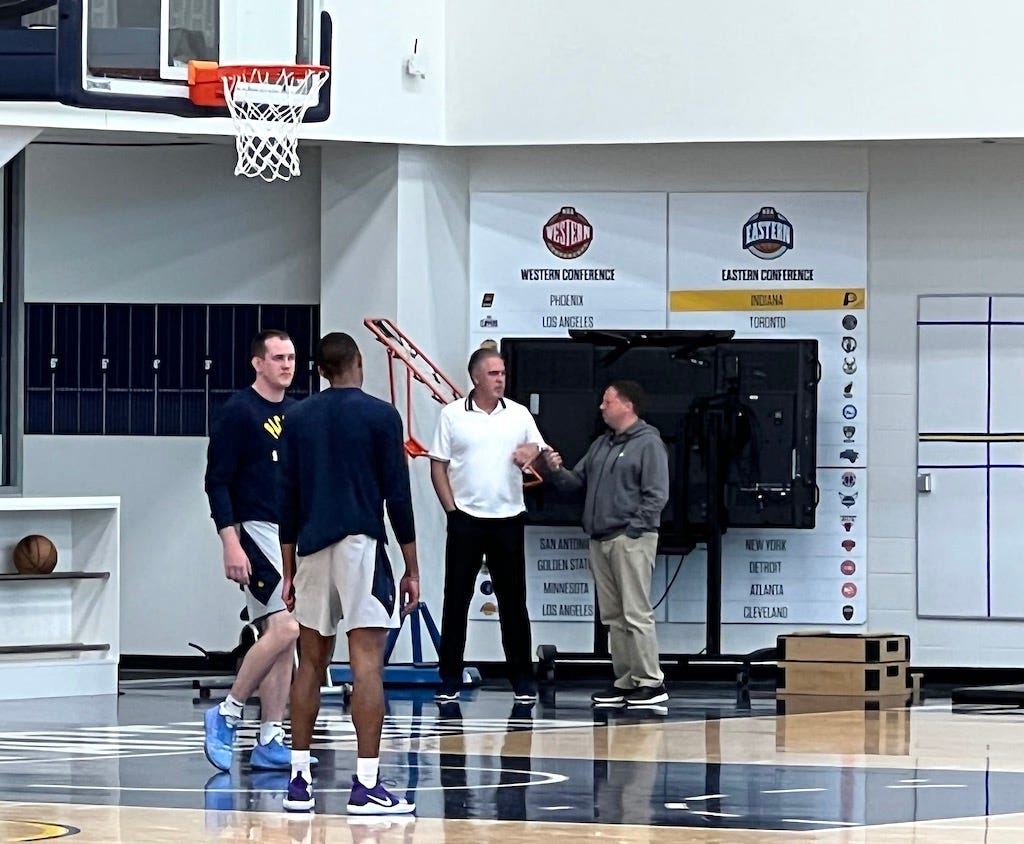 Pacers' Ryan Carr (right) talks with team president Kevin Pritchard after a workout.