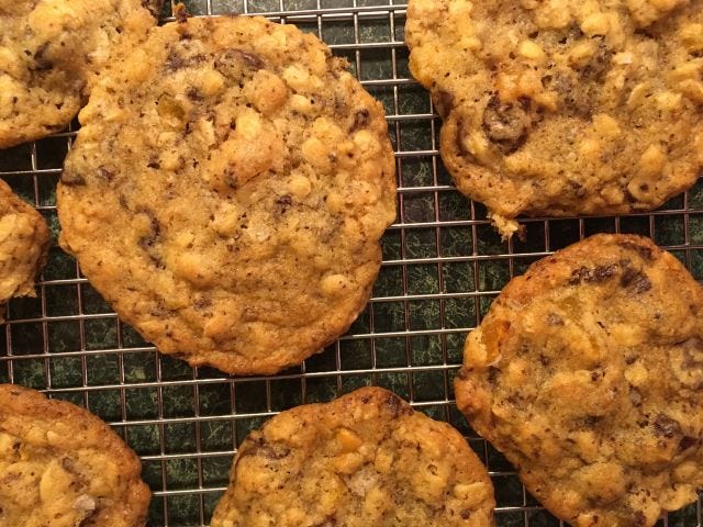 several chocolate chip cookies on a drying rack