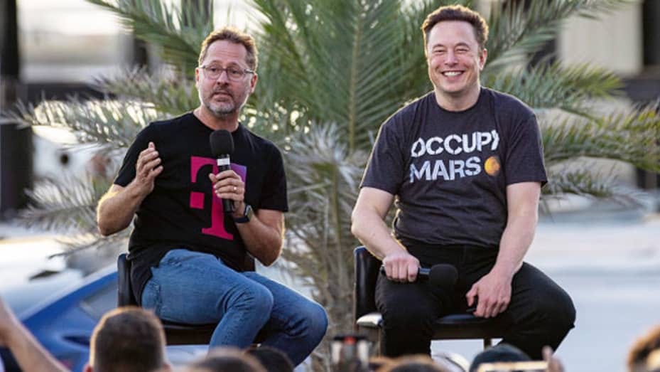 SpaceX founder Elon Musk and T-Mobile CEO Mike Sievert on stage during a T-Mobile and SpaceX joint event on August 25, 2022 in Boca Chica Beach, Texas.