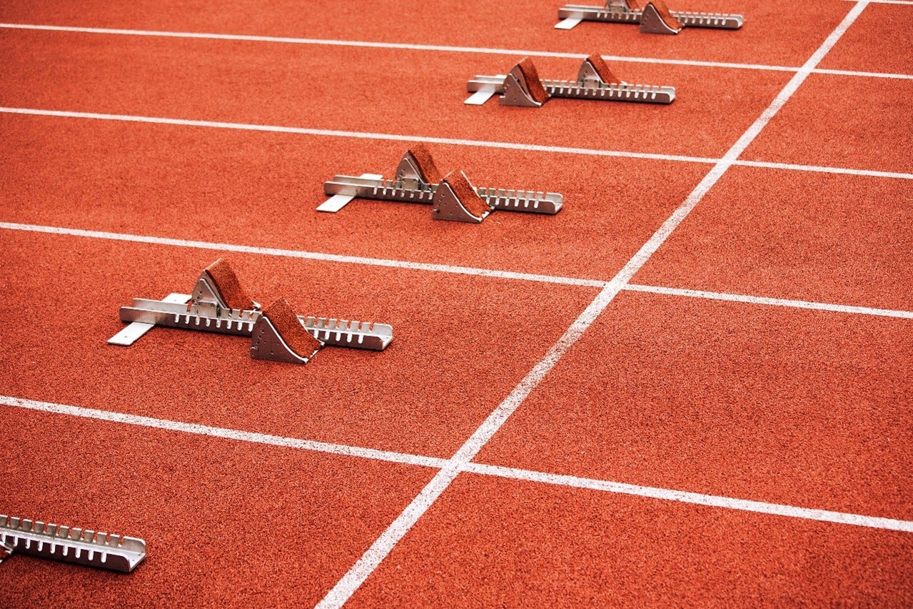 A stock photo of empty starters blocks on an athletics track