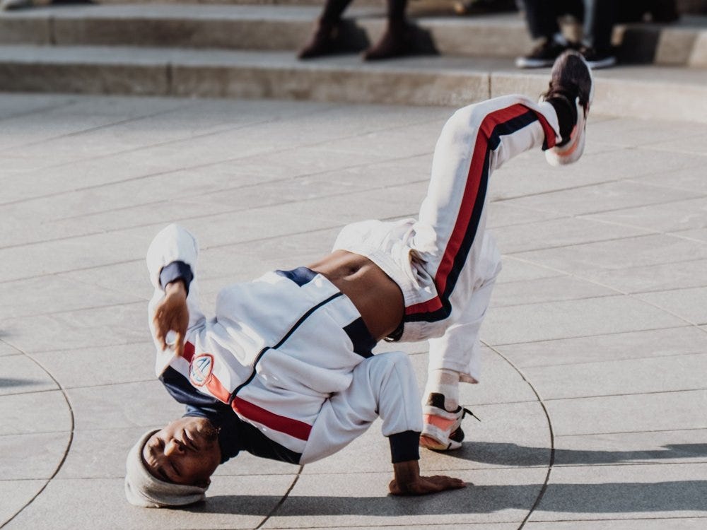 A breakdancer executes an upside-down manuever.