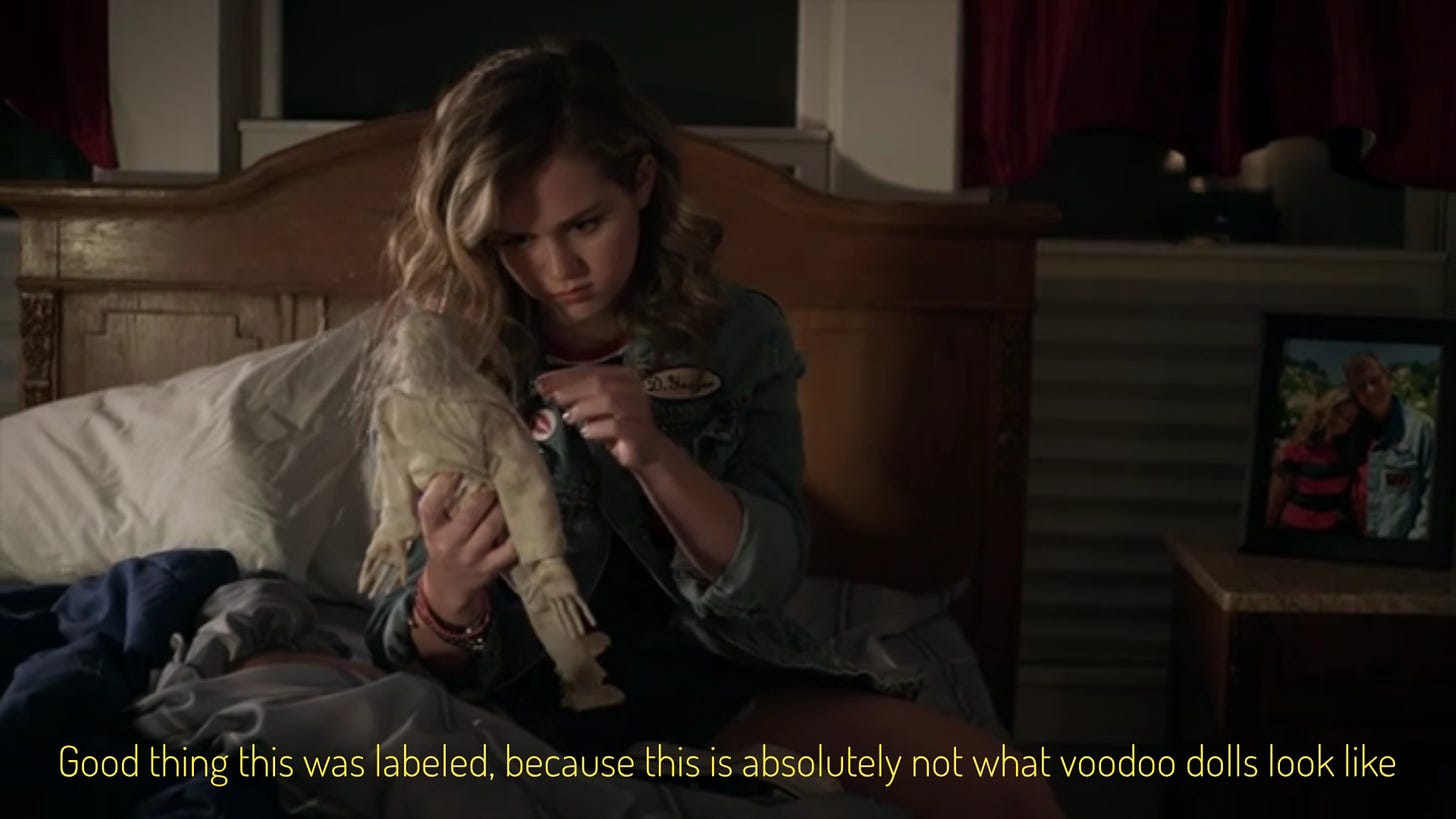 A teen girl with big curly dark blonde hair poking at a dirty floppy white doll, captioned "good thing this was labeled, because this is absolutely not what voodoo dolls look like"