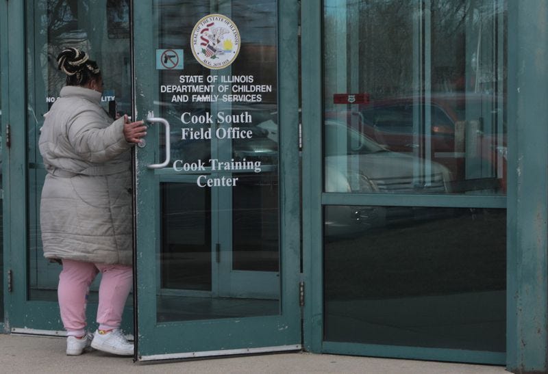 A woman enters an Illinois Department of Children and Family Services office in Chicago in 2019.