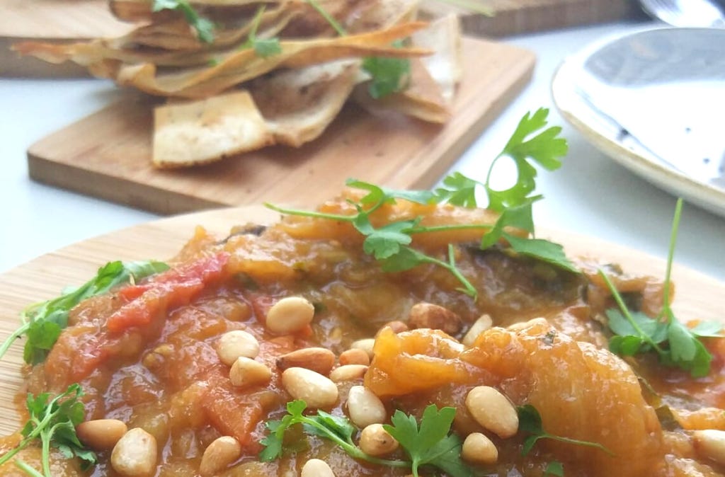 Zaalouk, a Morrocan dip made from aubergines and tomatoes, served on a wooden board