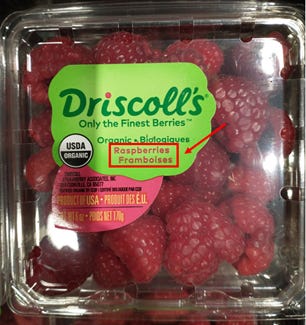 carton of raspberries, labeled in both english and french