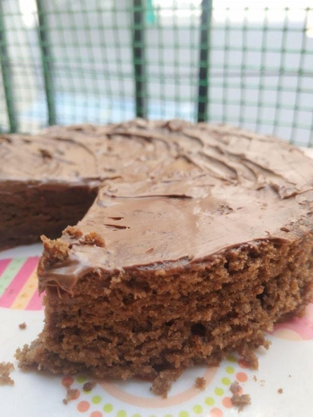 Close up of a brownie with nutella frosting on top.