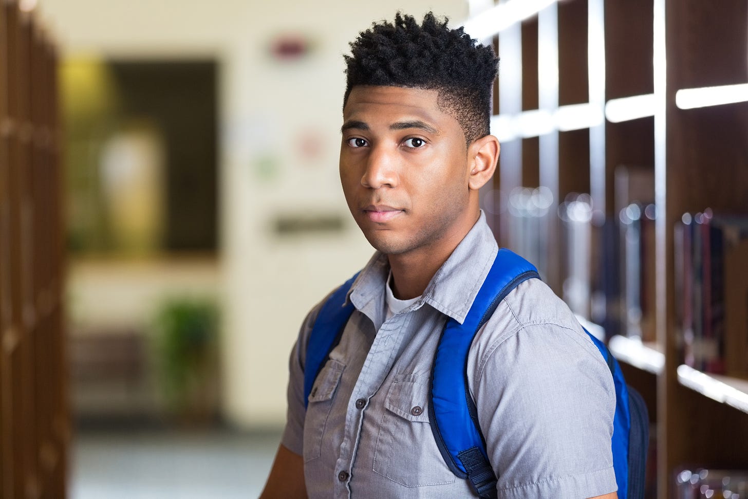 Serious African American high school boy in library | NNPA ESSA MEDIA  CAMPAIGN