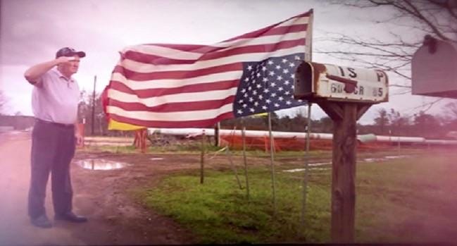 An elderly veteran saluting the American flag upside down for U.S. Code ...