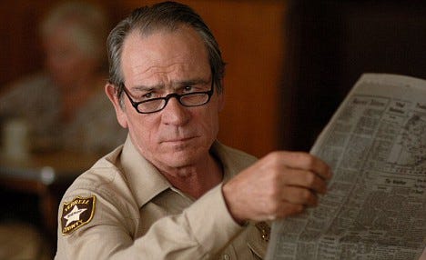 Tommy Lee Jones reading a newspaper and looking at you condescendingly. :  pics