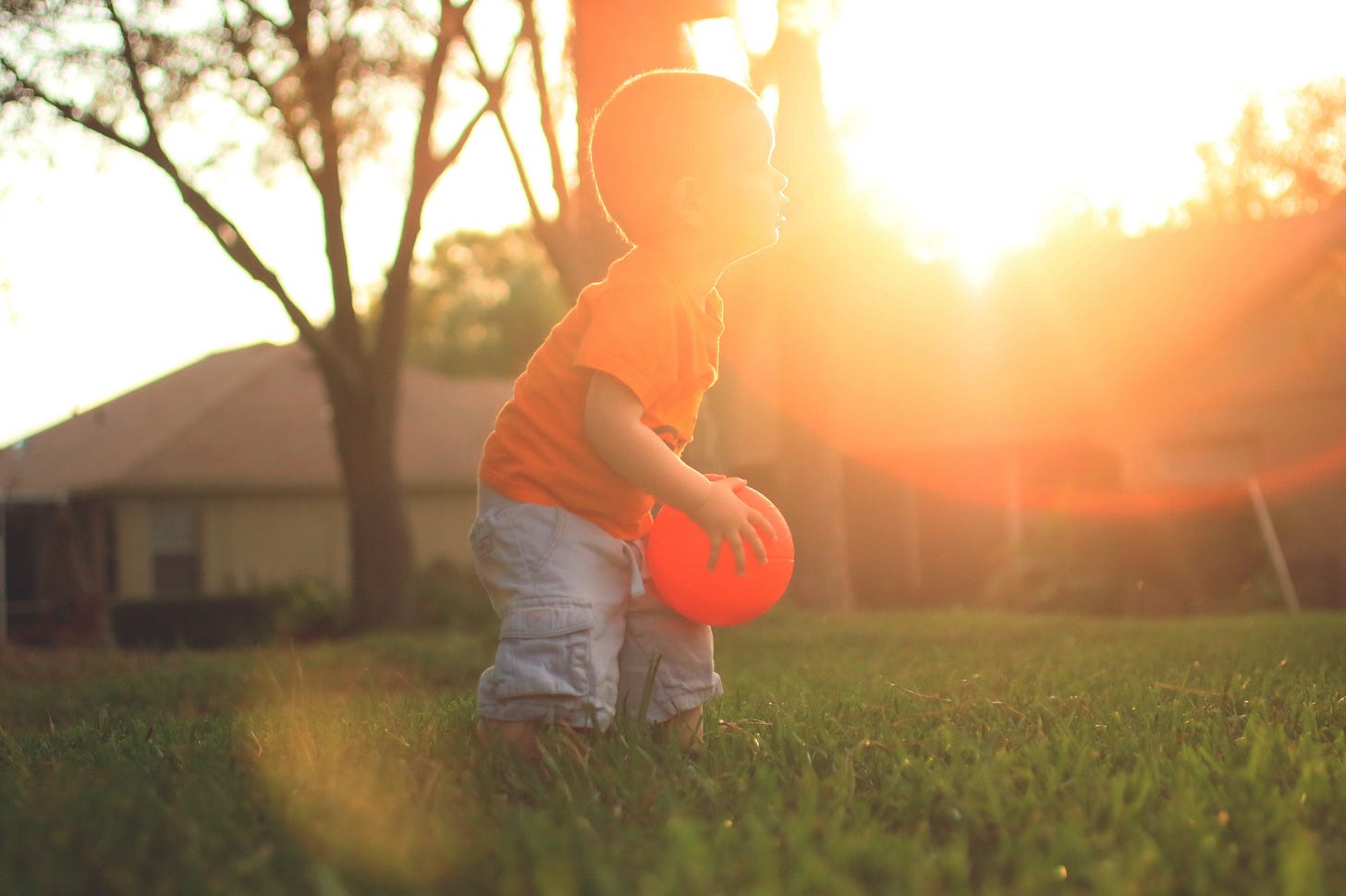 young boy playing ball in the yard for article by Larry G. Maguire