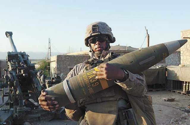 Lance Cpl. Ahmad Garland of Golf Battery, 2nd Battalion, 11th Marines, holds an M982 Excalibur round at Forward Operating Base Zeebrugge in Helmand province, Afghanistan, in April. Garland and other Golf Battery Marines fired an Excalibur round a record 36 kilometers on Feb. 12, killing a team of Taliban fighters.