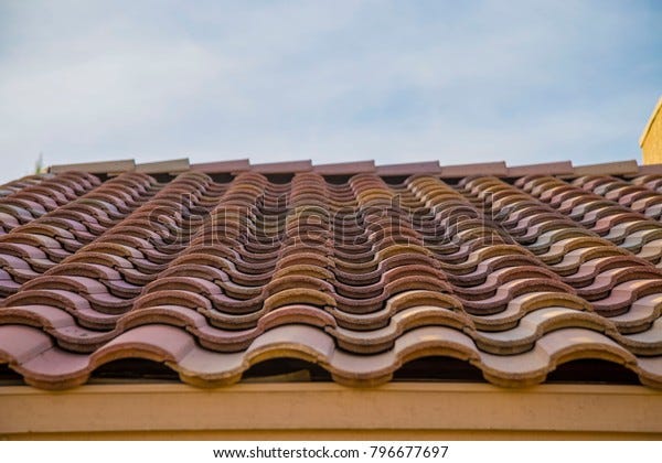 Terracotta roof blue sky spanish style house southwest corner edge gutter red  building arizona tucson home
