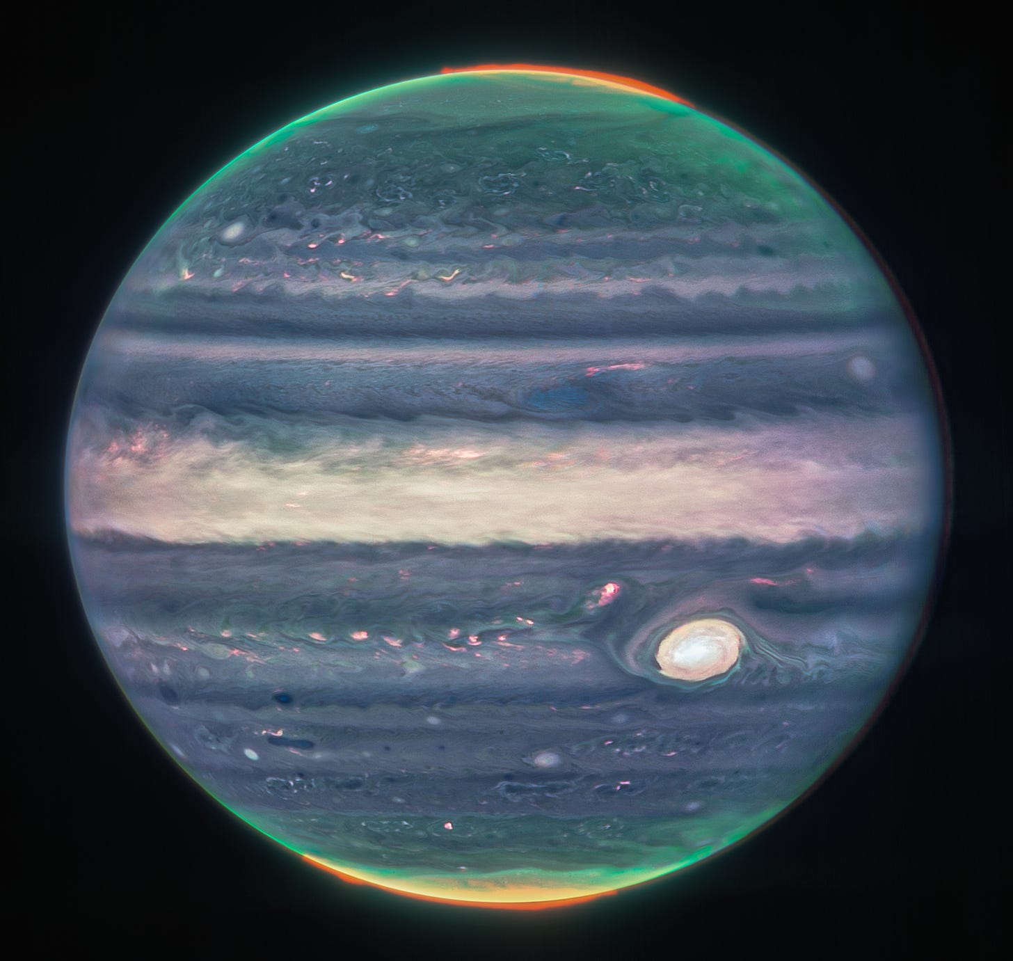 An image of Jupiter taken with the Webb telescope. It has purple white and blue bands with some green and orange glowing at the poles.