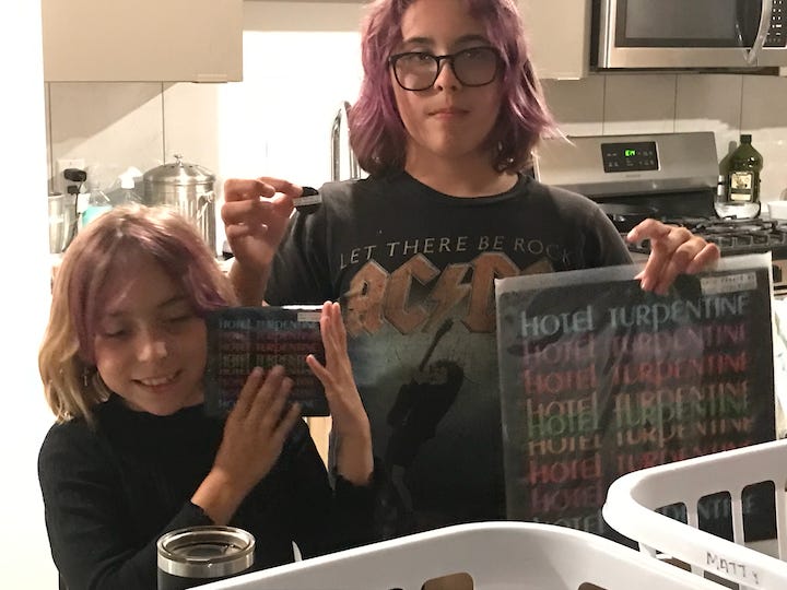 The author's kids hold up newly arrived music from Minnesota's Rank Strangers.