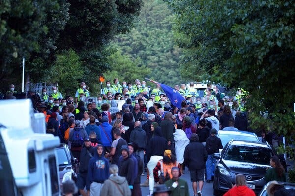 Demonstrators and the police outside of the Parliament grounds in Wellington, New Zealand, on Tuesday.
