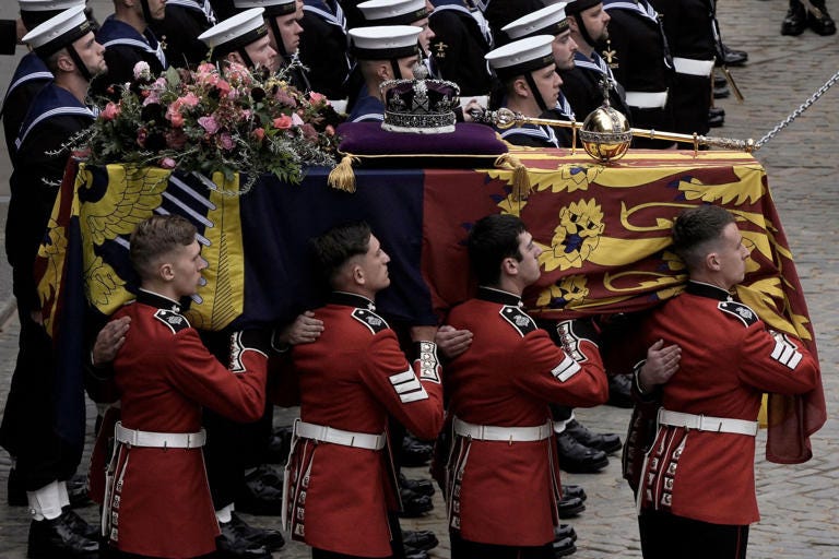 The coffin of Queen Elizabeth II is loaded onto a gun carriage, which was pulled by royal navy sailors on its journey from from Westminster Hall for the funeral service in Westminster Abbey. Nariman El-Mofty—Pool/AP