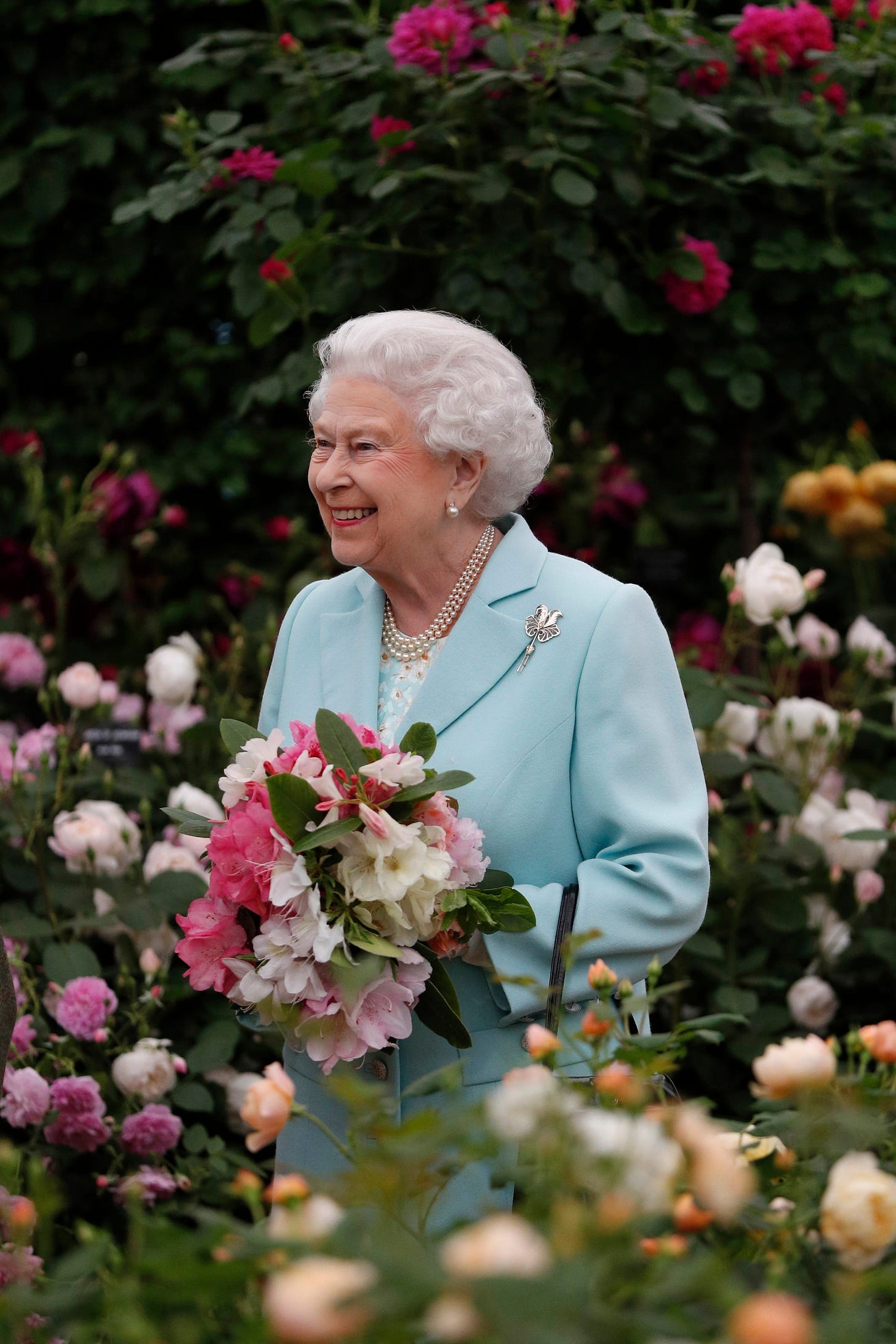 Image may contain Elizabeth II Plant Flower Blossom Human Person Flower Bouquet Flower Arrangement and Rose