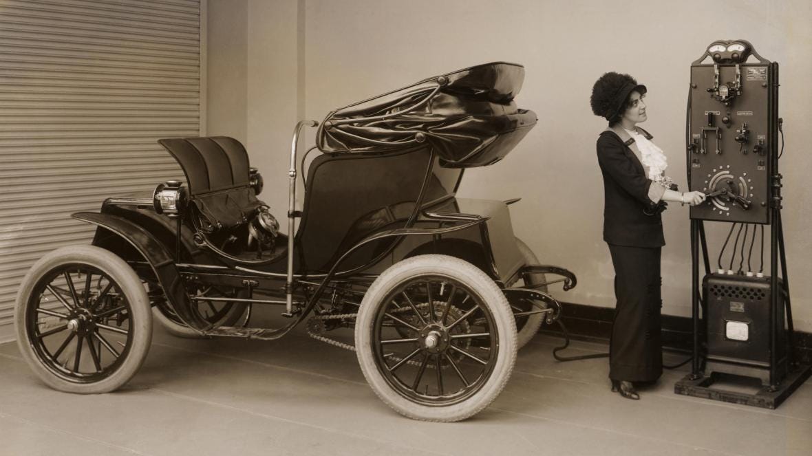 A woman charges her Columbia Mark 68 Victoria electric car