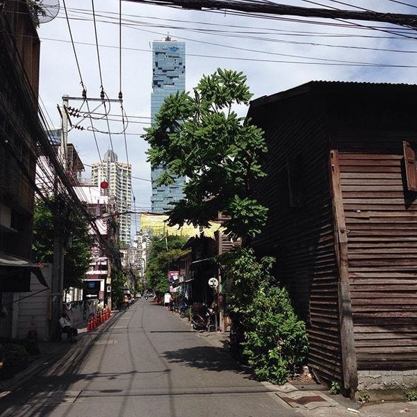 The Mahanakhon Tower and old wooden houses still hanging in there. - Bangkok.