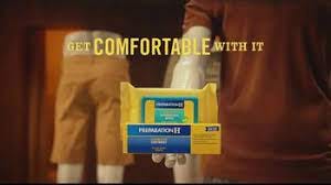 a series of butts in shorts are pictured behind a tube of Preparation H