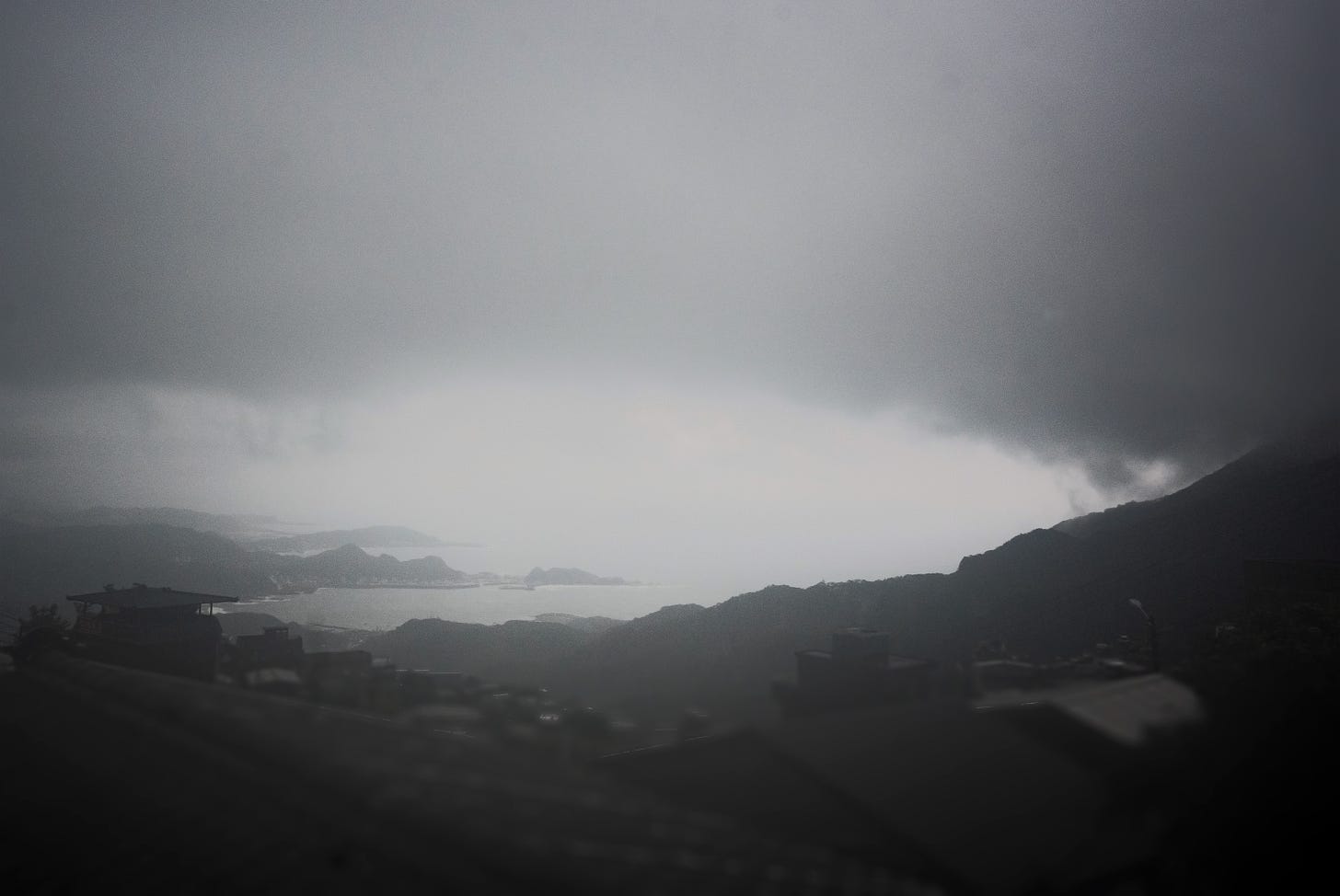 Dramatic clouds hang low over the bay below Jiufen, a vista made famous by Hou Hsiao-hsien's "City of Sadness"
