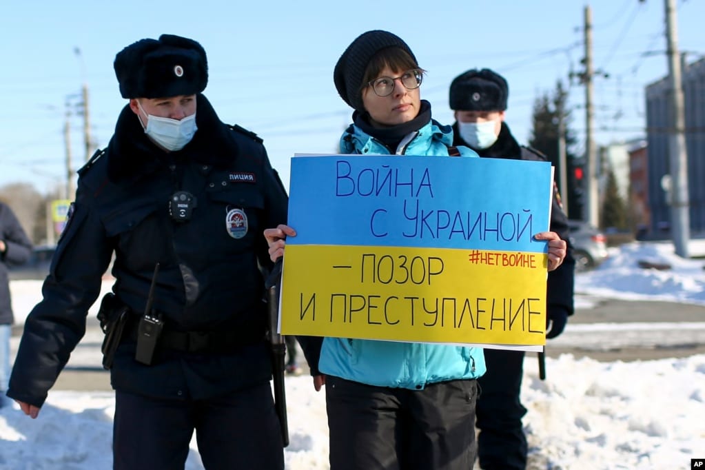 Police detain a demonstrator with a poster which reads &quot;The war with Ukraine is a shame and a crime&quot; during an action against Russia&#39;s attack on Ukraine in Omsk, Russia, Feb. 27, 2022.