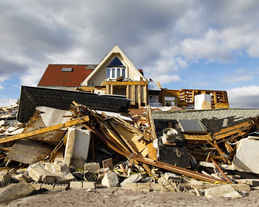 A house is left in shambles after a storm rips down walls and half the roof.