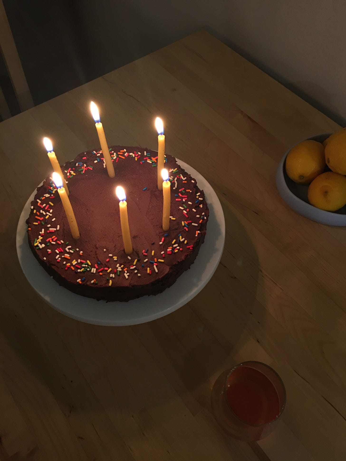 Chocolate birthday cake with sprinkles and candles