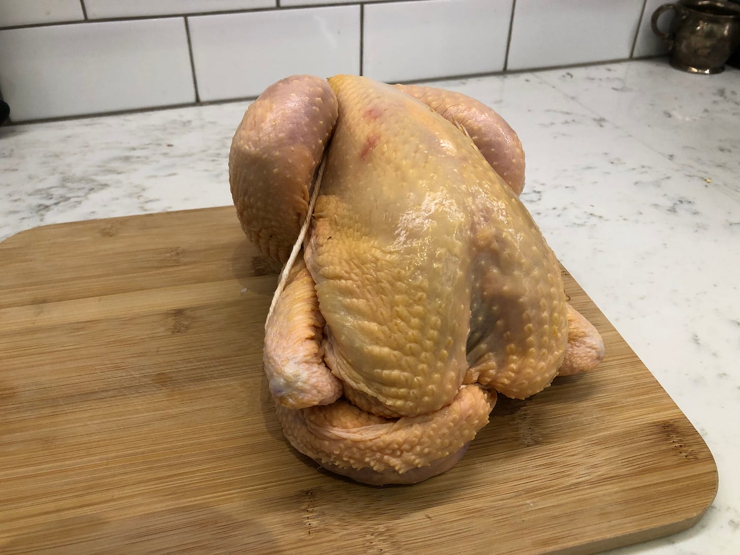 Raw chicken on cutting board