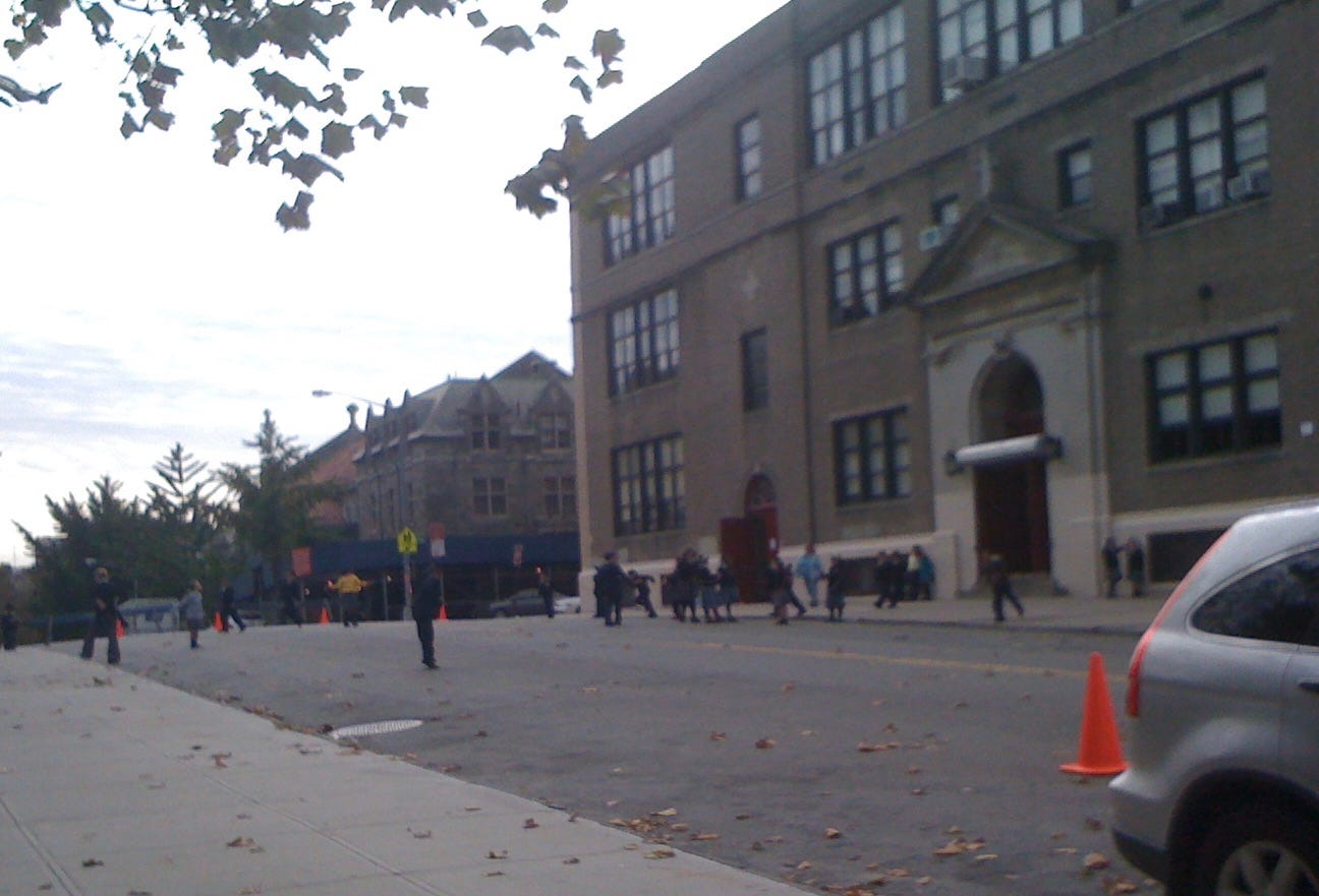 Children play on the road outside an upper Manhattan school
