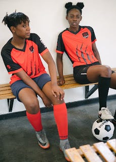 young soccer players on bench