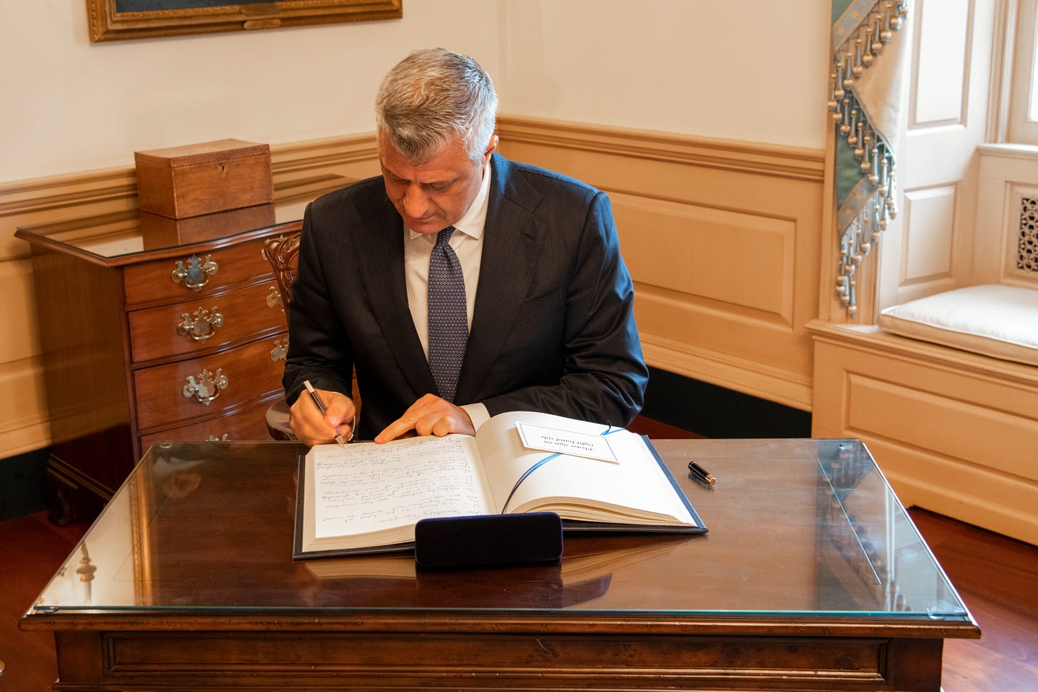 Photo of then-Kosovan President Hashim Thaçi signing the US State Department guestbook in February 2020