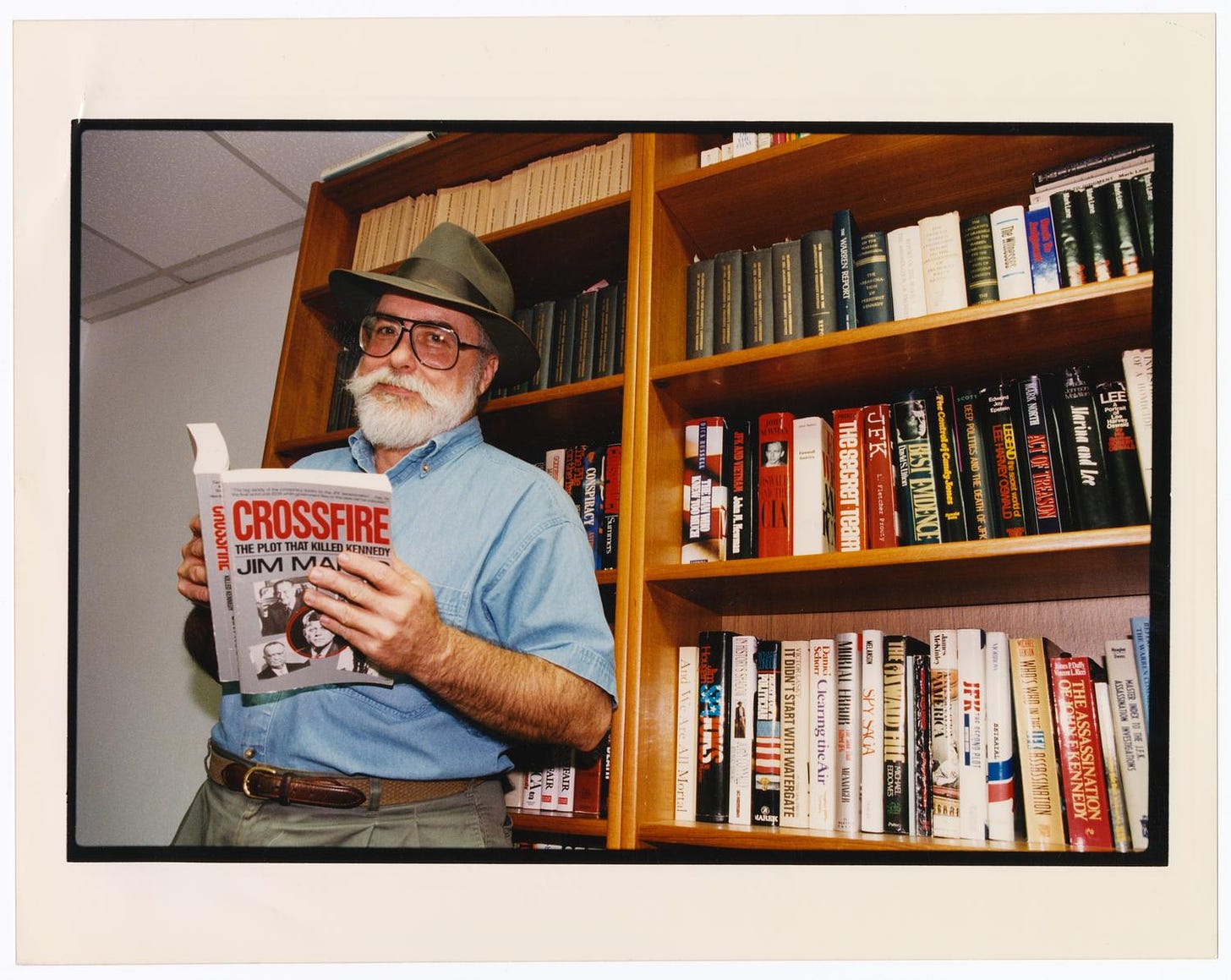 Portrait of Jim Marrs with his book] - The Portal to Texas History