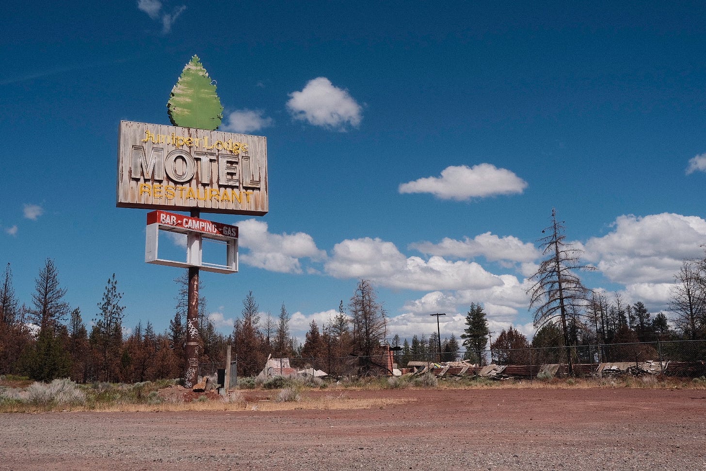 The old Juniper Lodge Motel and restaurant sign on the side of the road in California.