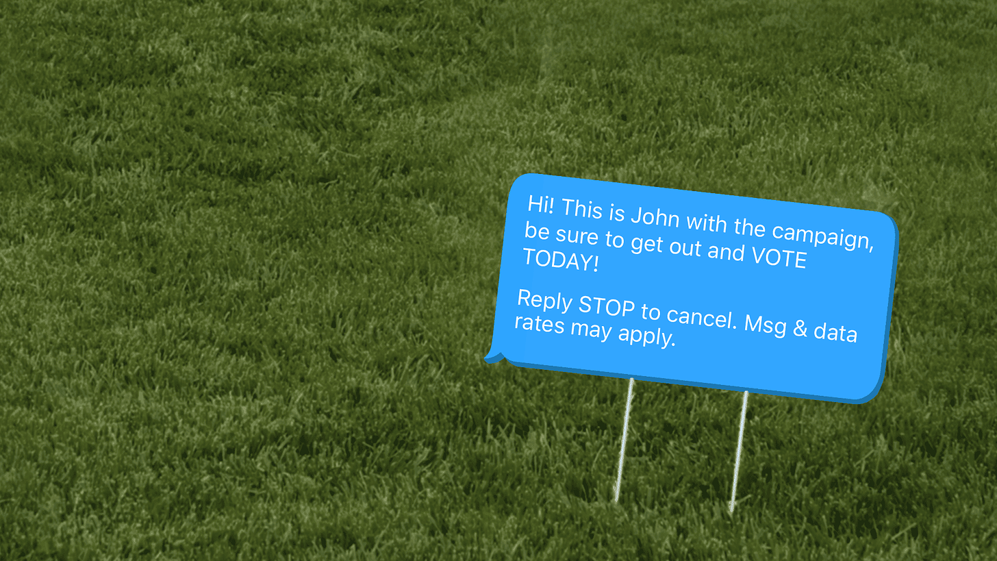 An image of a political spam text on grass, aka a modern-day lawn sign.