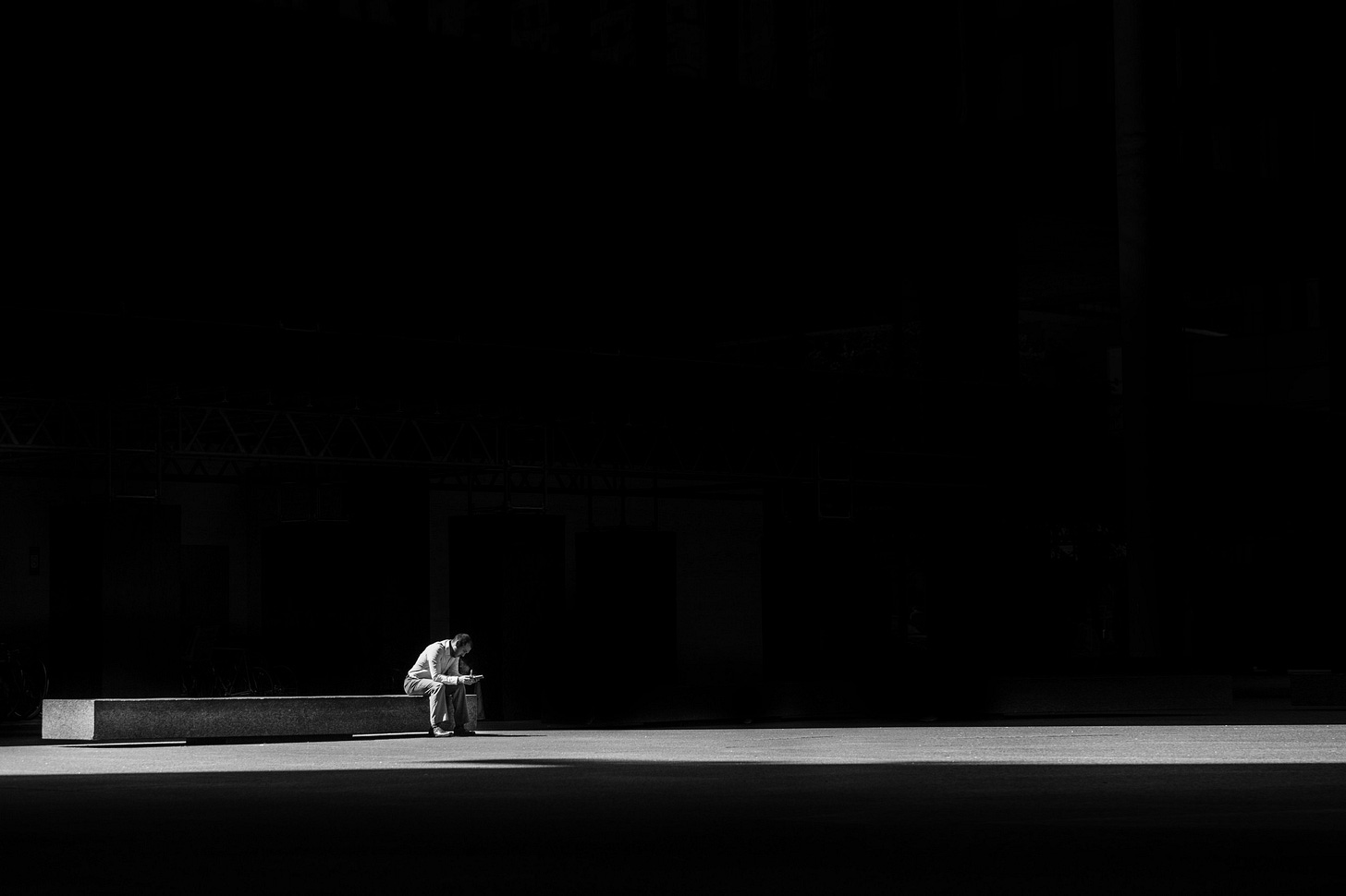 Black and white image of a man sitting on a bench for article titled “the closest I’ve come”