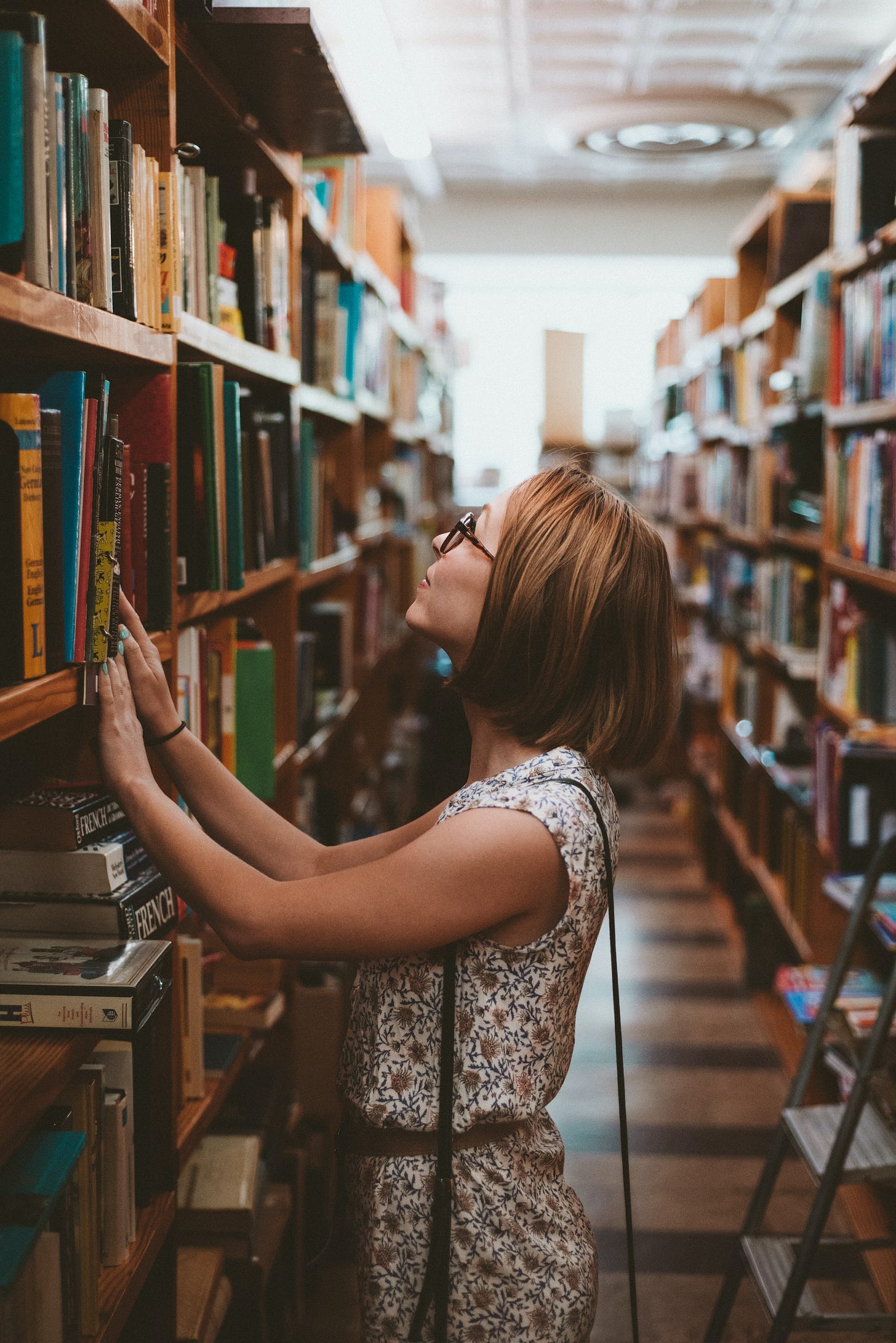 Woman looking for a book in a used bookstore.